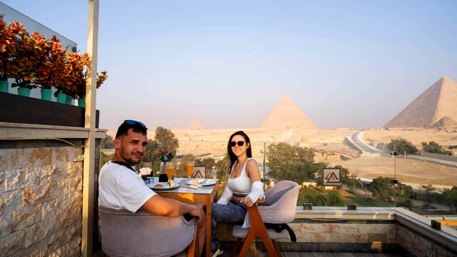 Cairo: Sunrise Camel Ride, Pyramids Tour & Local Breakfast. - Breakfast with the pyramids in the background